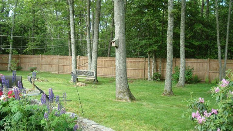 851 Cotuit Road Mashpee, MA 02649 - Photo 4 of 5 a view of a backyard with a garden and plants