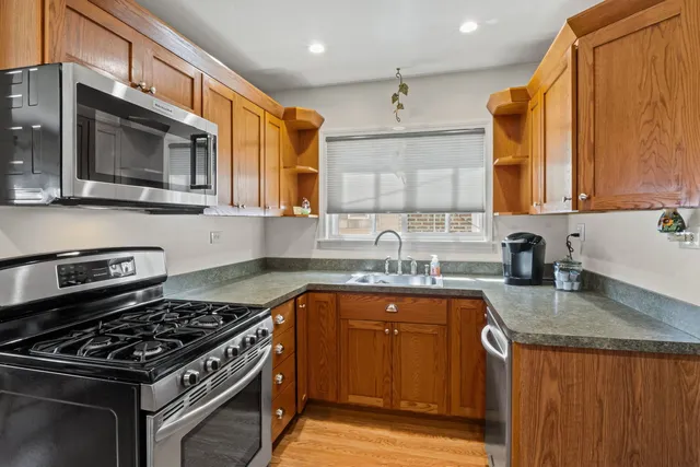 a kitchen with stainless steel appliances granite countertop a stove a sink dishwasher and microwave oven with granite countertops