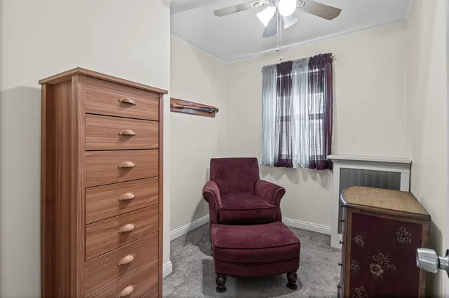 a living room with furniture and a dresser