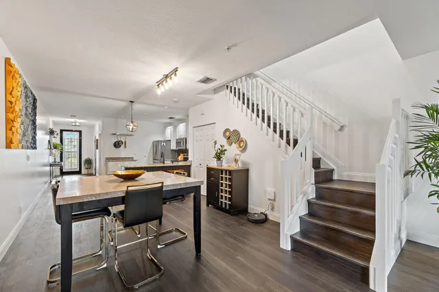 a view of a dining room with furniture and wooden floor