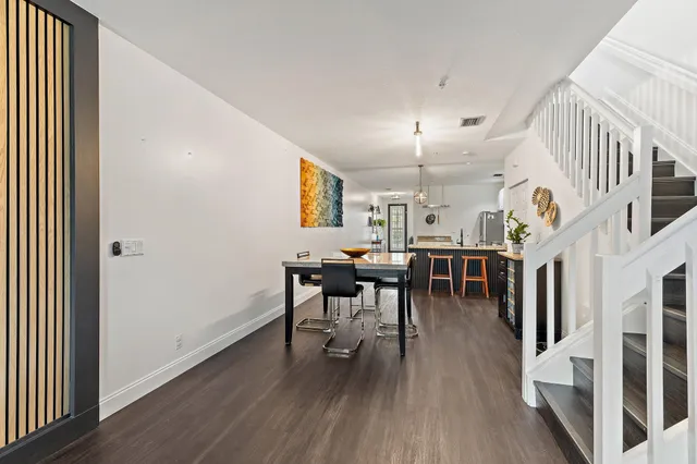 a view of a dining room with furniture and wooden floor