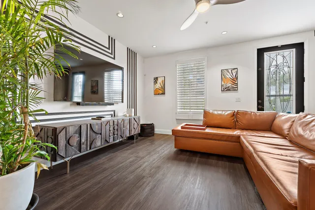 a living room with furniture and wooden floor