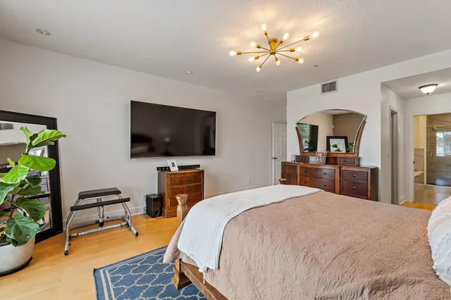 a bedroom with a bed and a flat screen tv