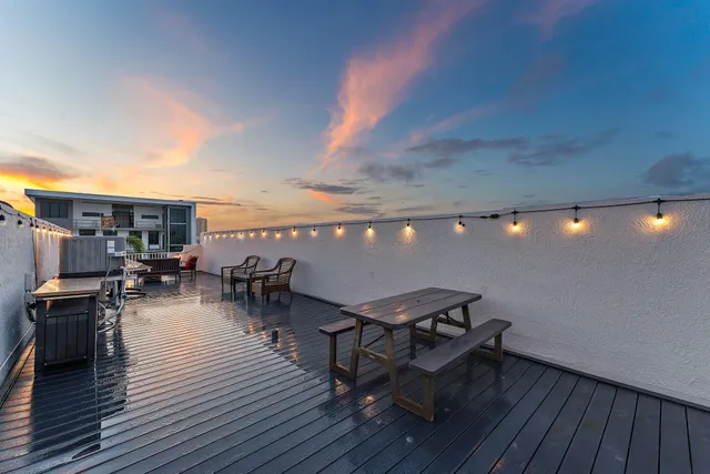 a view of a chairs and table on the wooden deck