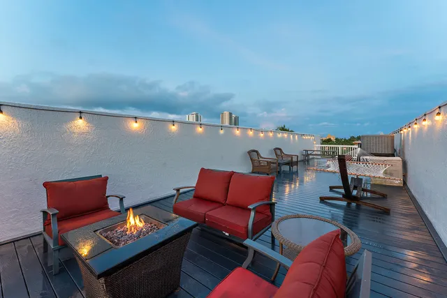 a outdoor sitting area with a couch and wooden floor