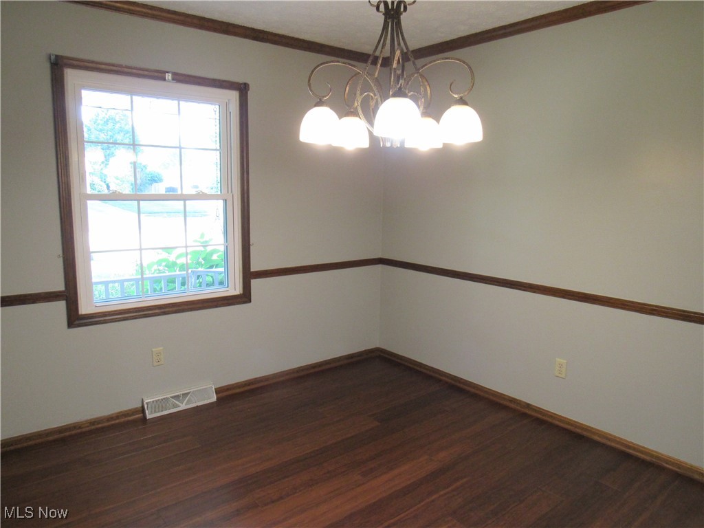 1120 Vincent Road Southeast North Canton, OH 44720 - Photo 13 of 50 Dining Room with chair rail, crown molding, chandelier and Bamboo flooring