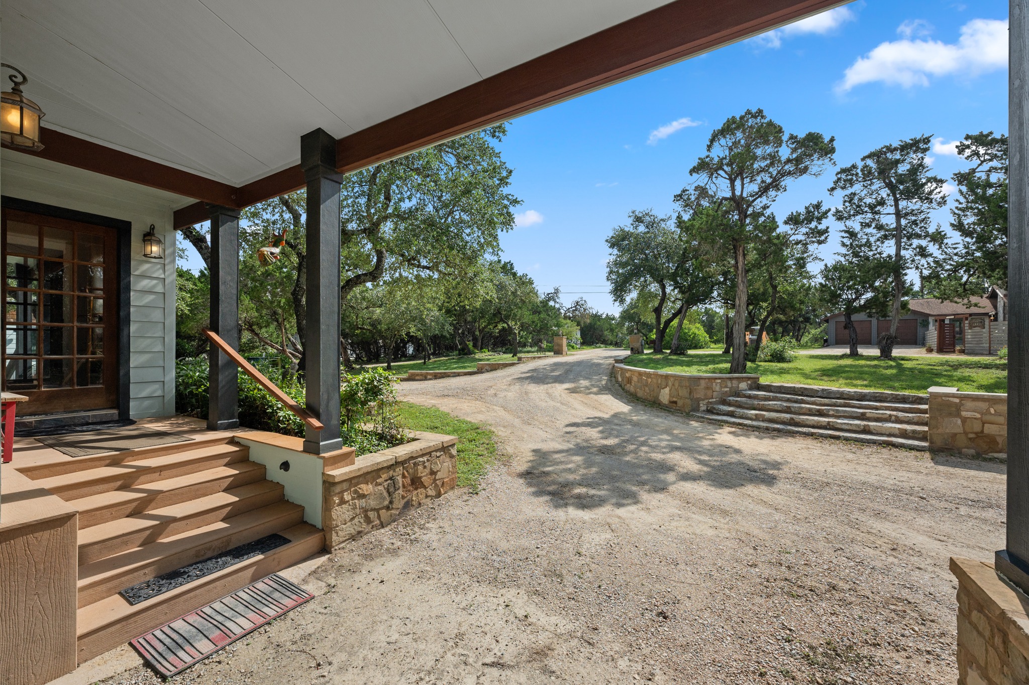 12932 Nutty Brown Road Austin, TX 78737 - Photo 5 of 40 The Manor - Expansive outdoor living area designed for gathering, entertaining, and taking in the Hill Country views.
