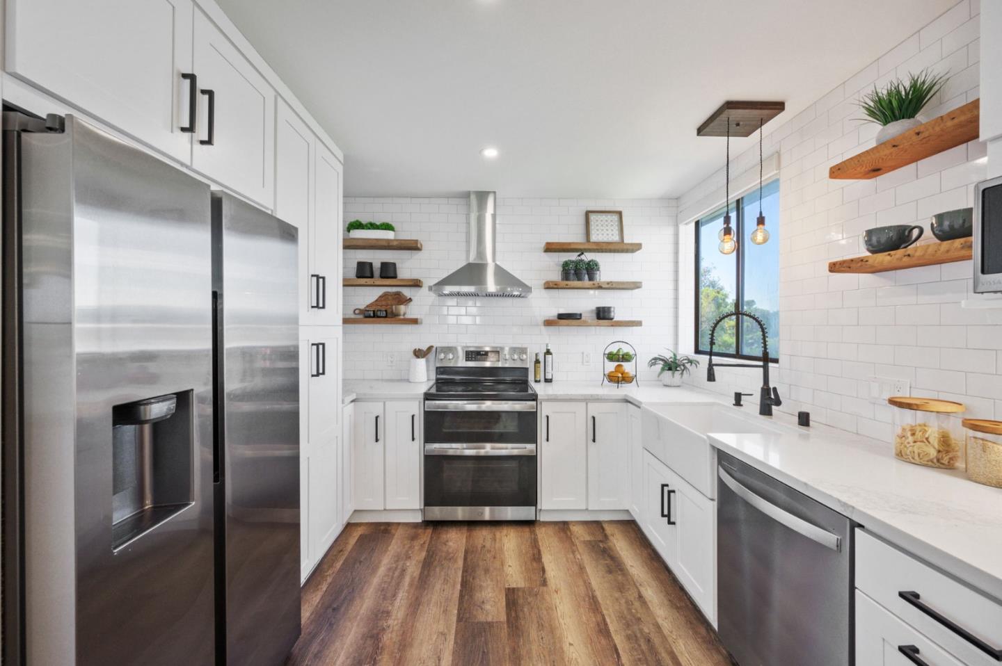 425 Anchor Road, Unit 317 San Mateo, CA 94404 - Photo 18 of 53 a kitchen with stainless steel appliances a refrigerator sink and white cabinets