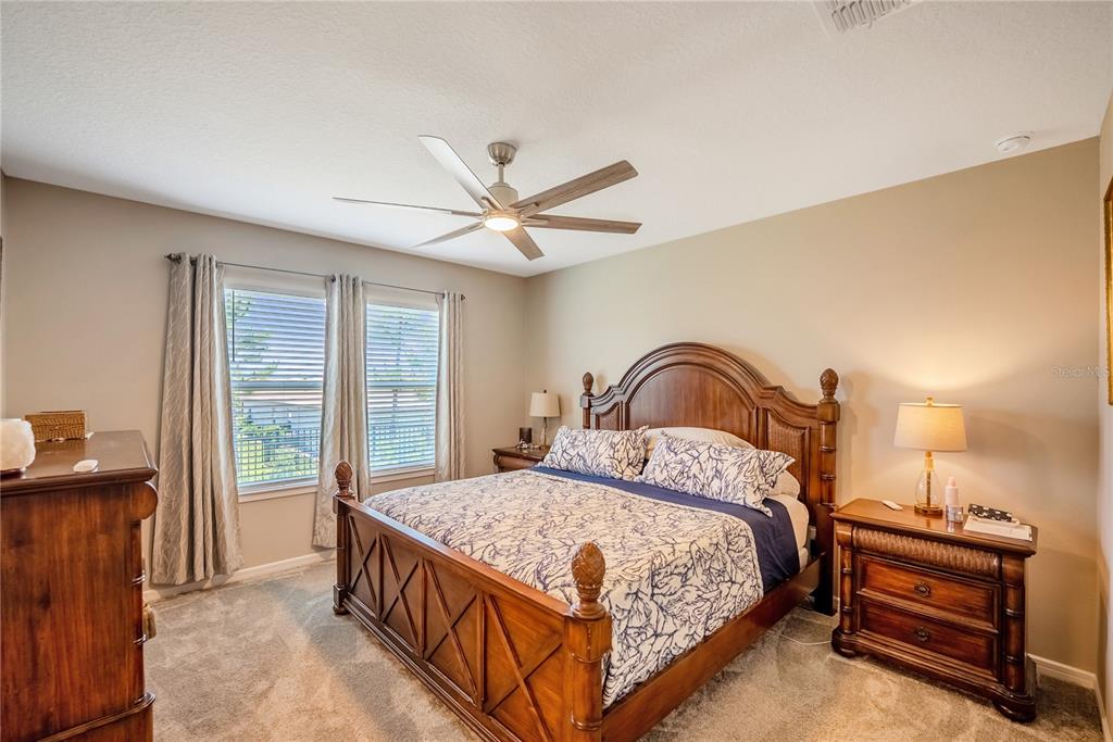 8344 Southwest 54th Loop Ocala, FL 34481 - Photo 11 of 36 a bedroom with a bed and a large window with rug