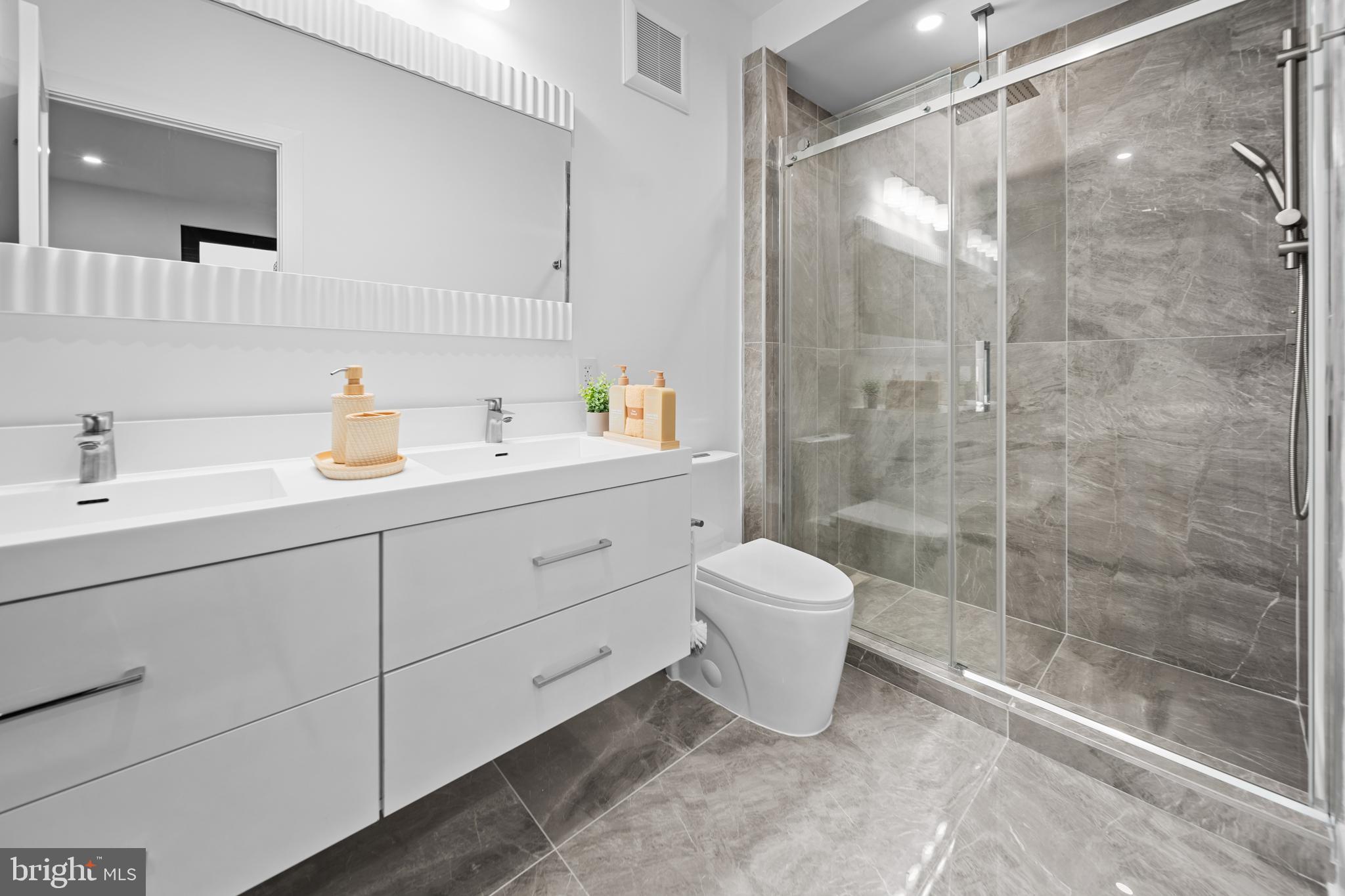 1121 Morse Street Northeast, Unit 3 Washington, DC 20002 - Photo 17 of 25 a bathroom with a sink toilet and shower