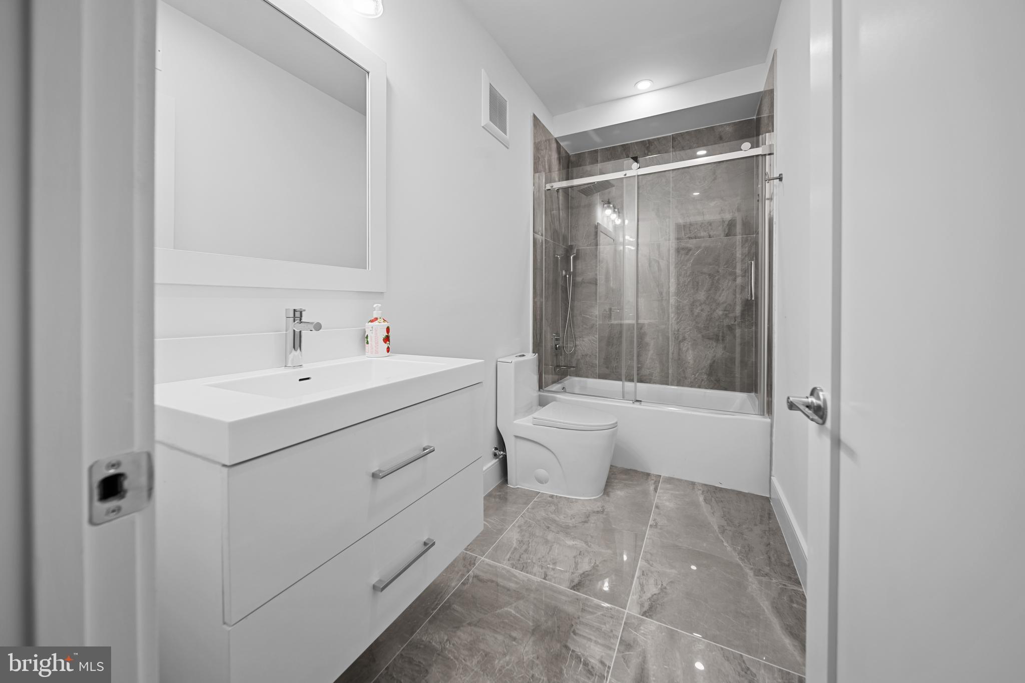 1121 Morse Street Northeast, Unit 3 Washington, DC 20002 - Photo 19 of 25 a bathroom with a sink toilet and shower