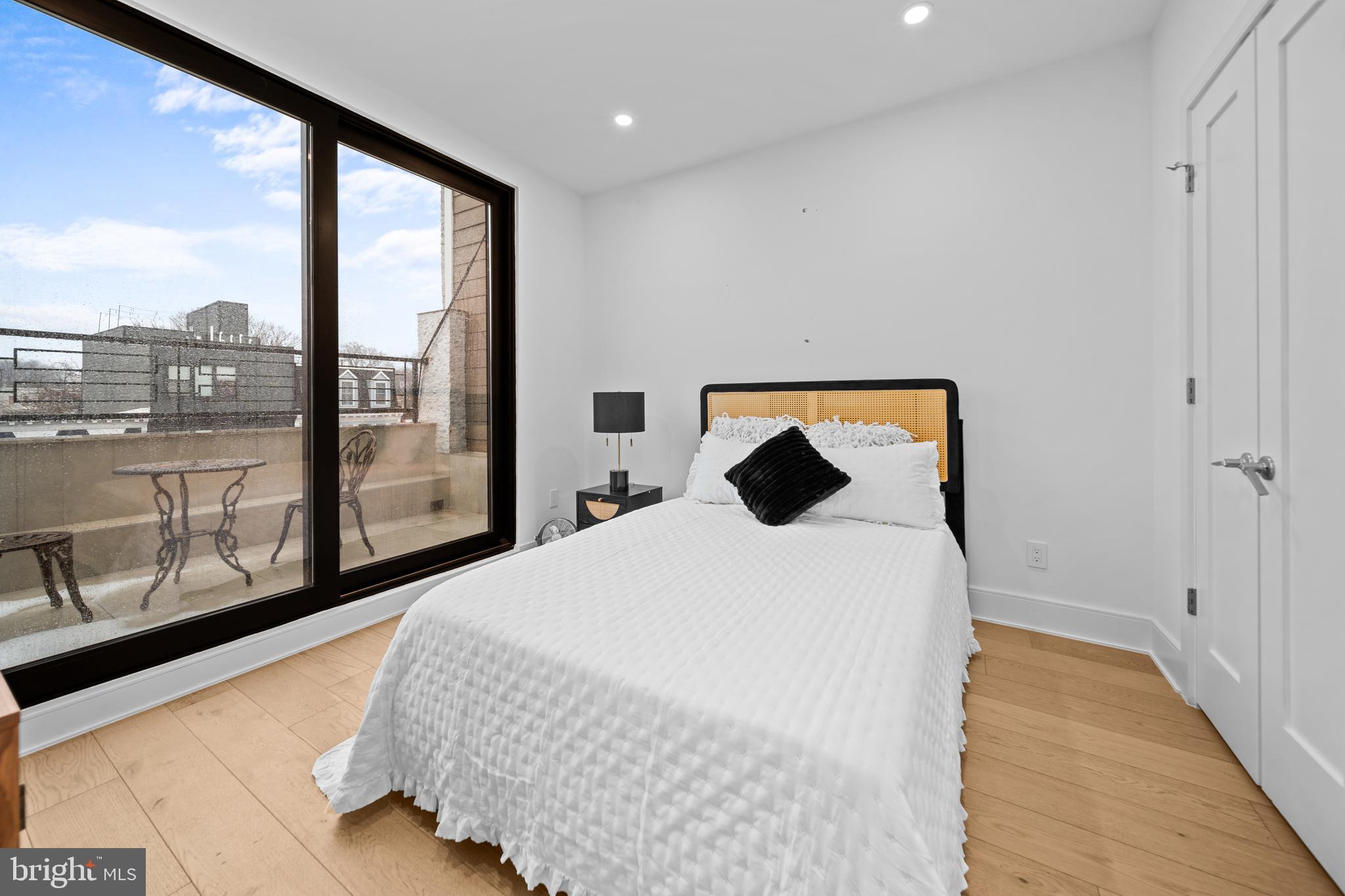 1121 Morse Street Northeast, Unit 3 Washington, DC 20002 - Photo 20 of 25 a bedroom with a large bed and a large window