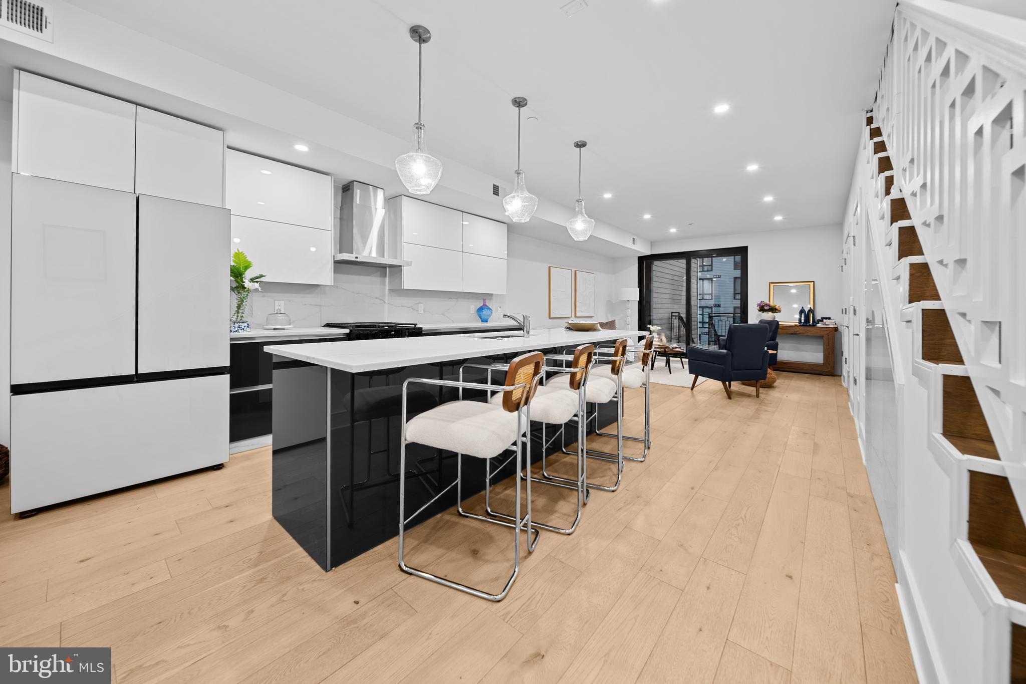 1121 Morse Street Northeast, Unit 3 Washington, DC 20002 - Photo 6 of 25 a kitchen with stainless steel appliances kitchen island granite countertop a sink and a refrigerator