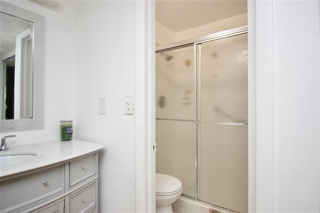 8150 West McNab Road, Unit 312 Tamarac, FL 33321 - Photo 13 of 32 a bathroom with a shower sink vanity mirror and toilet