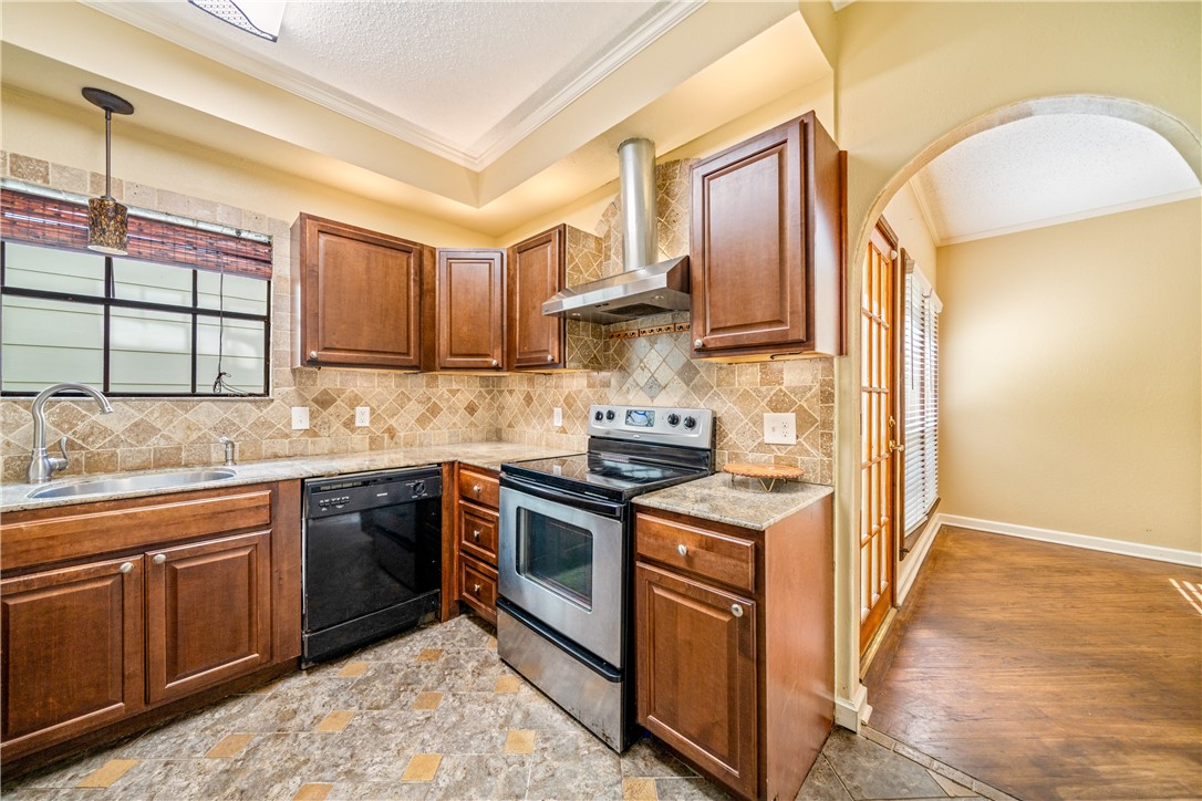 3052 Quail Springs Road, Unit A3 Corpus Christi, TX 78414 - Photo 12 of 27 a kitchen with stainless steel appliances granite countertop a stove and a sink