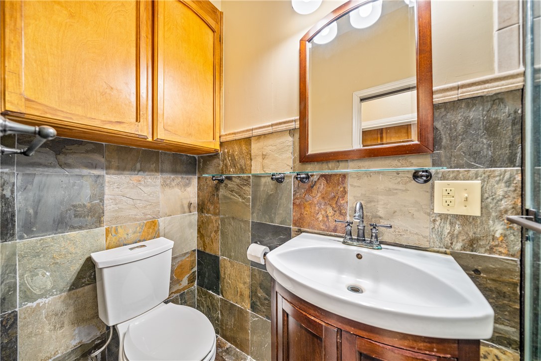 3052 Quail Springs Road, Unit A3 Corpus Christi, TX 78414 - Photo 14 of 27 a bathroom with a sink a toilet and a mirror