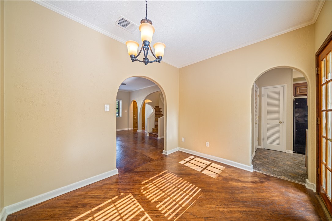 3052 Quail Springs Road, Unit A3 Corpus Christi, TX 78414 - Photo 5 of 27 a view of a room with a chandelier and wooden floor