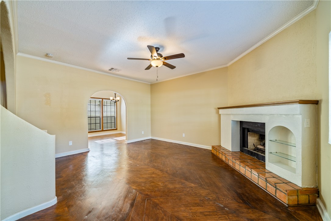3052 Quail Springs Road, Unit A3 Corpus Christi, TX 78414 - Photo 6 of 27 a view of an empty room with chandelier and fireplace