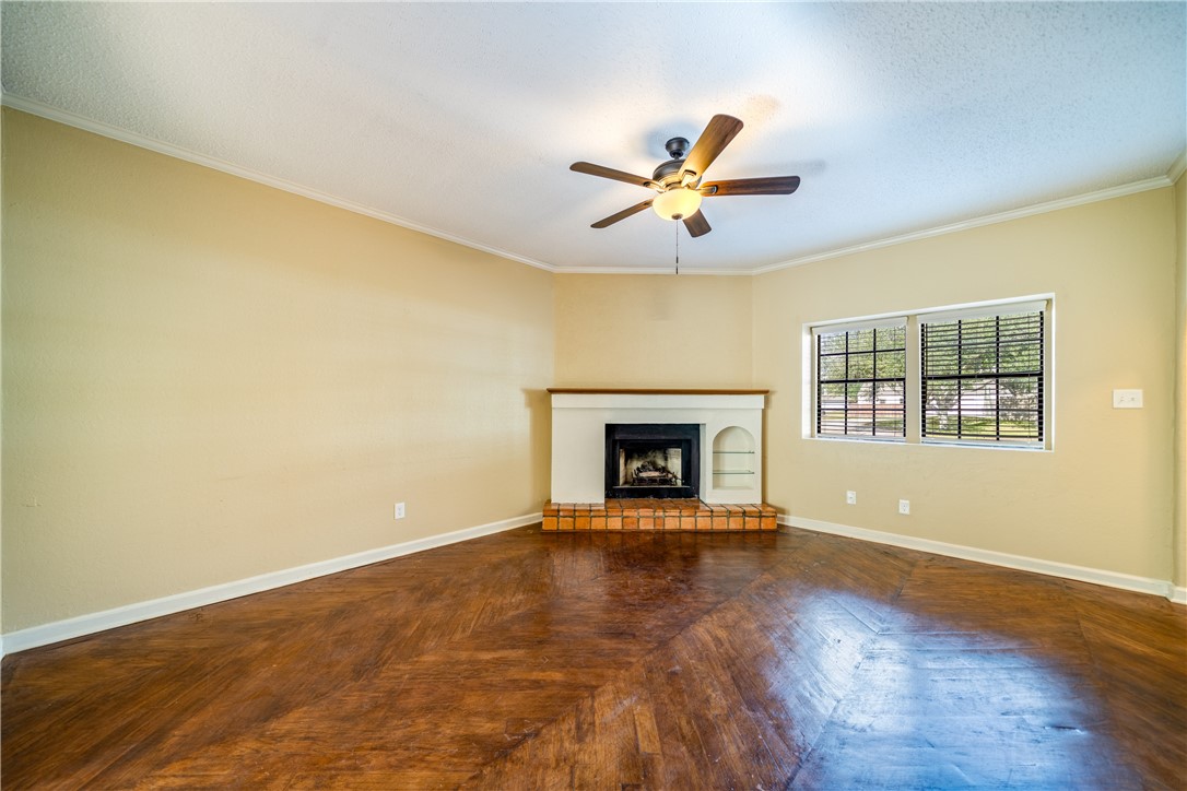3052 Quail Springs Road, Unit A3 Corpus Christi, TX 78414 - Photo 7 of 27 a view of an empty room with a window and a fireplace