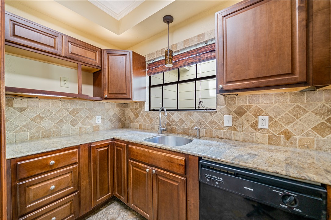 3052 Quail Springs Road, Unit A3 Corpus Christi, TX 78414 - Photo 10 of 27 a kitchen with granite countertop sink and cabinets