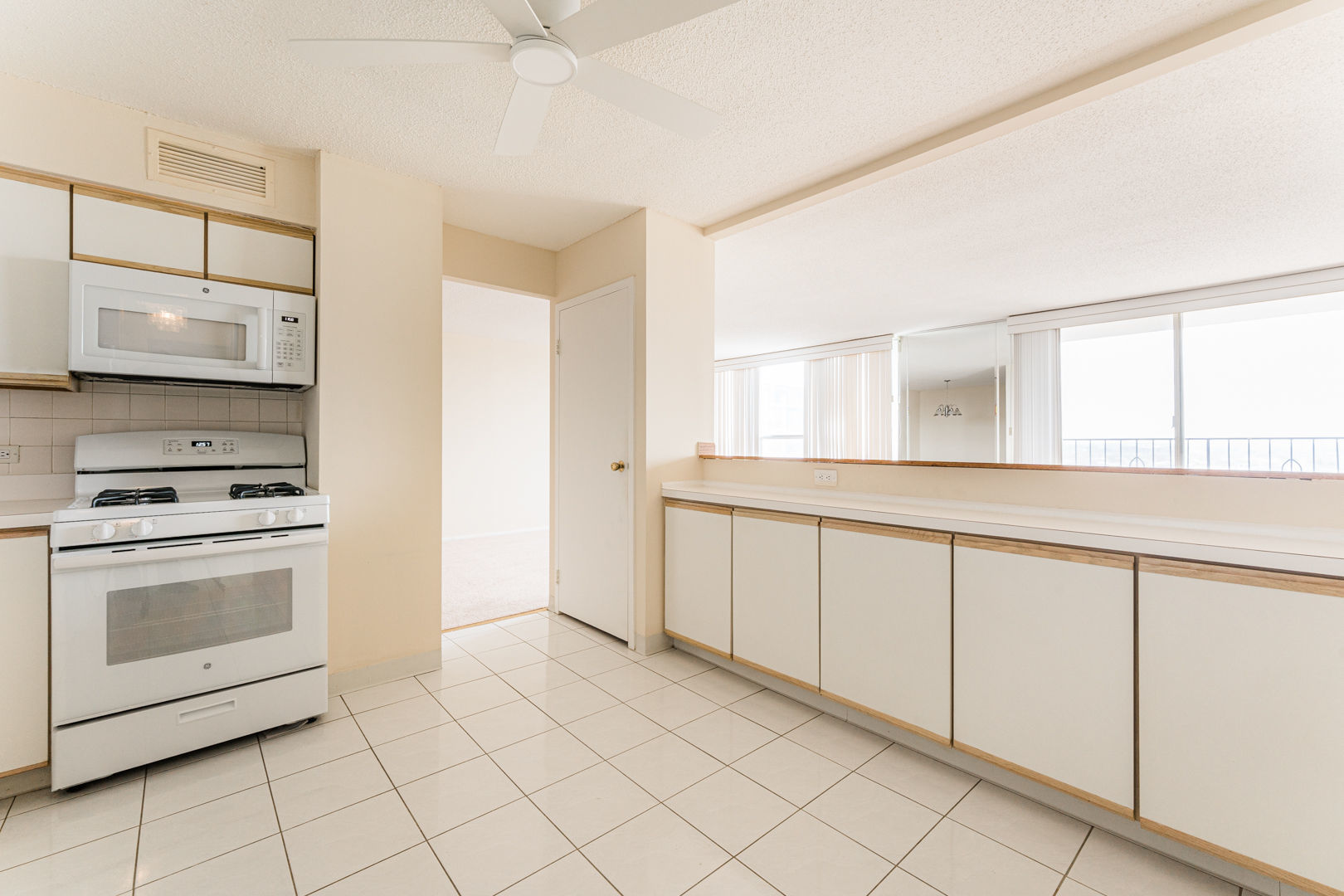 8801 Golf Road, Unit 10D Niles, IL 60714 - Photo 7 of 24 a kitchen with granite countertop white cabinets and white appliances