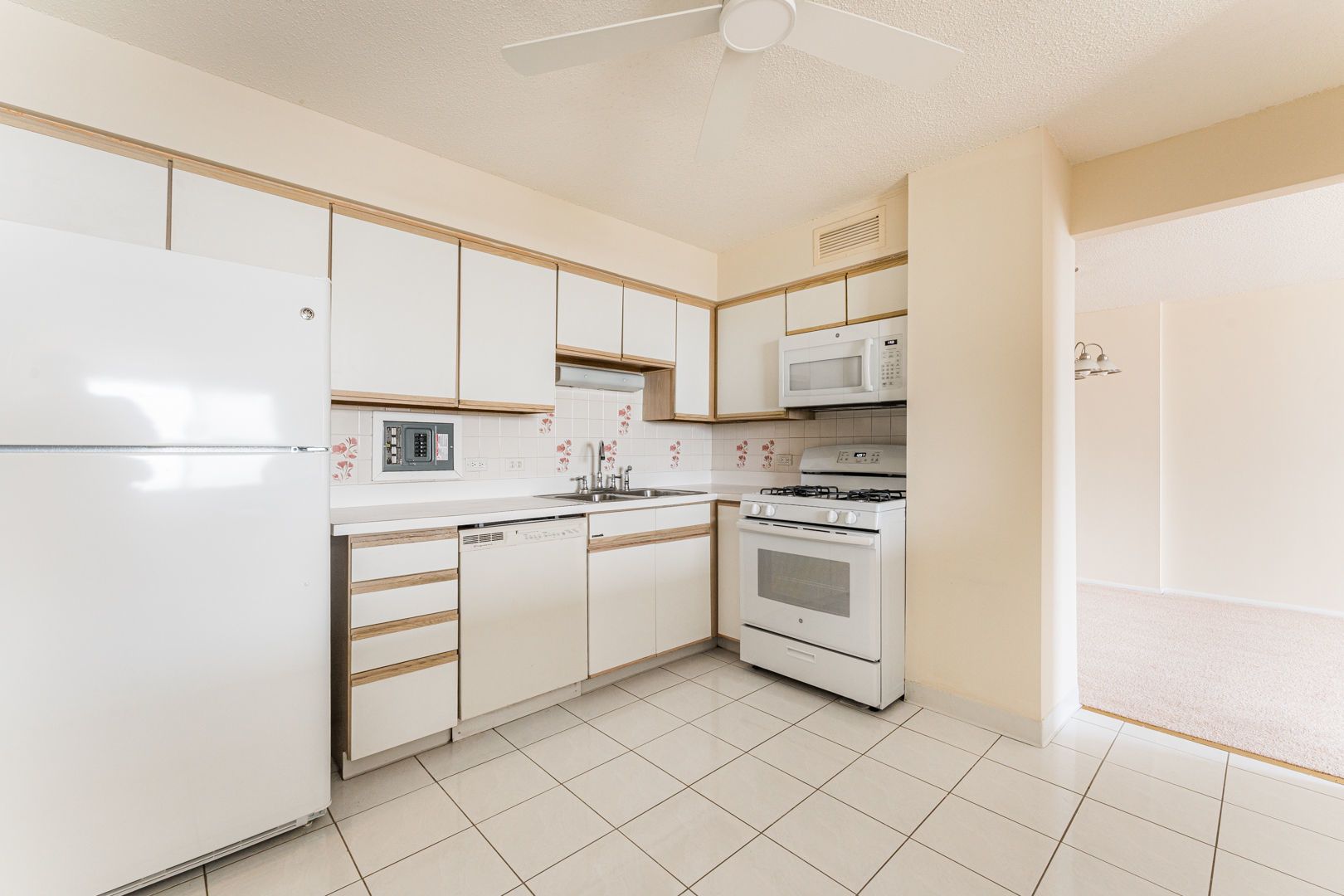 8801 Golf Road, Unit 10D Niles, IL 60714 - Photo 8 of 24 a kitchen with white cabinets a sink and white appliances