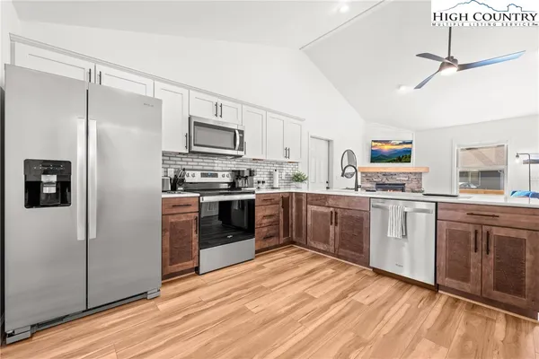 a kitchen with stainless steel appliances a refrigerator sink and cabinets