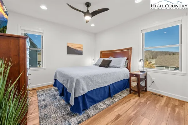 a bedroom with a bed dresser and a window