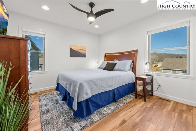 a bedroom with a bed dresser and a window