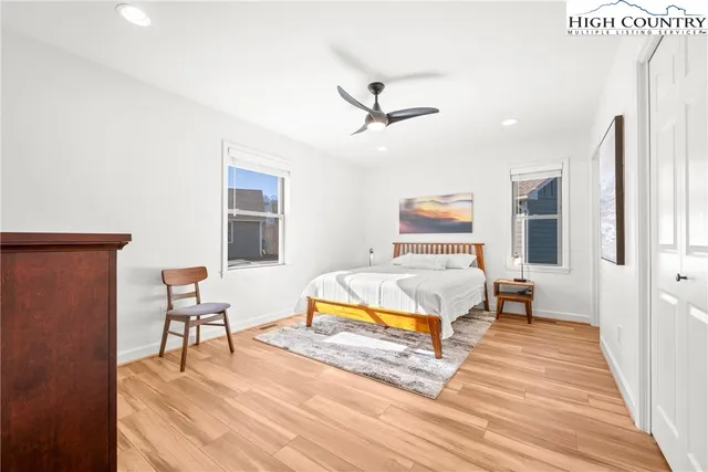 a bedroom with a bed and wooden floor