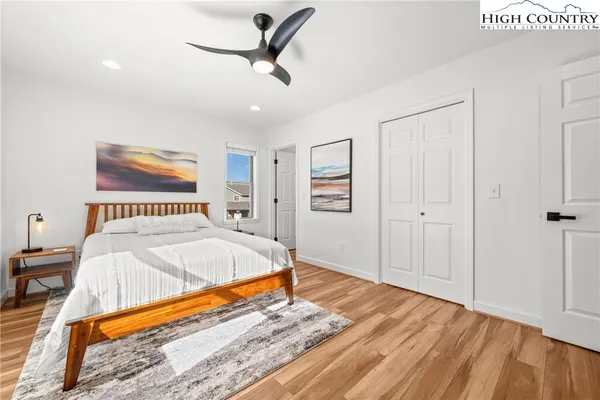 a bed room with a bed and a ceiling fan