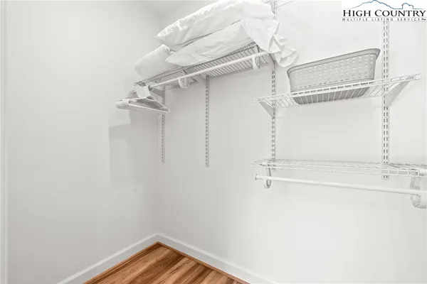 a view of walk in closet with empty racks