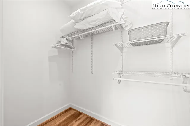 a view of walk in closet with empty racks