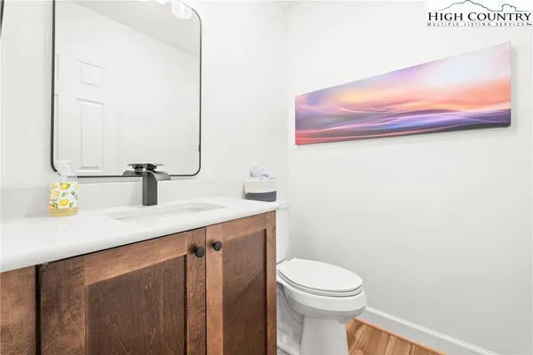 a bathroom with a sink a toilet and mirror