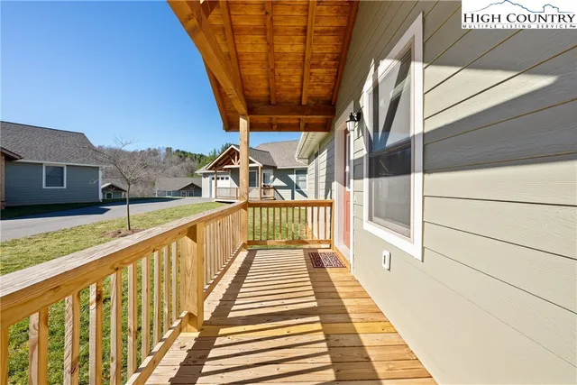 a view of balcony with wooden floor and fence