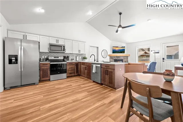 a kitchen with cabinets a sink and stainless steel appliances