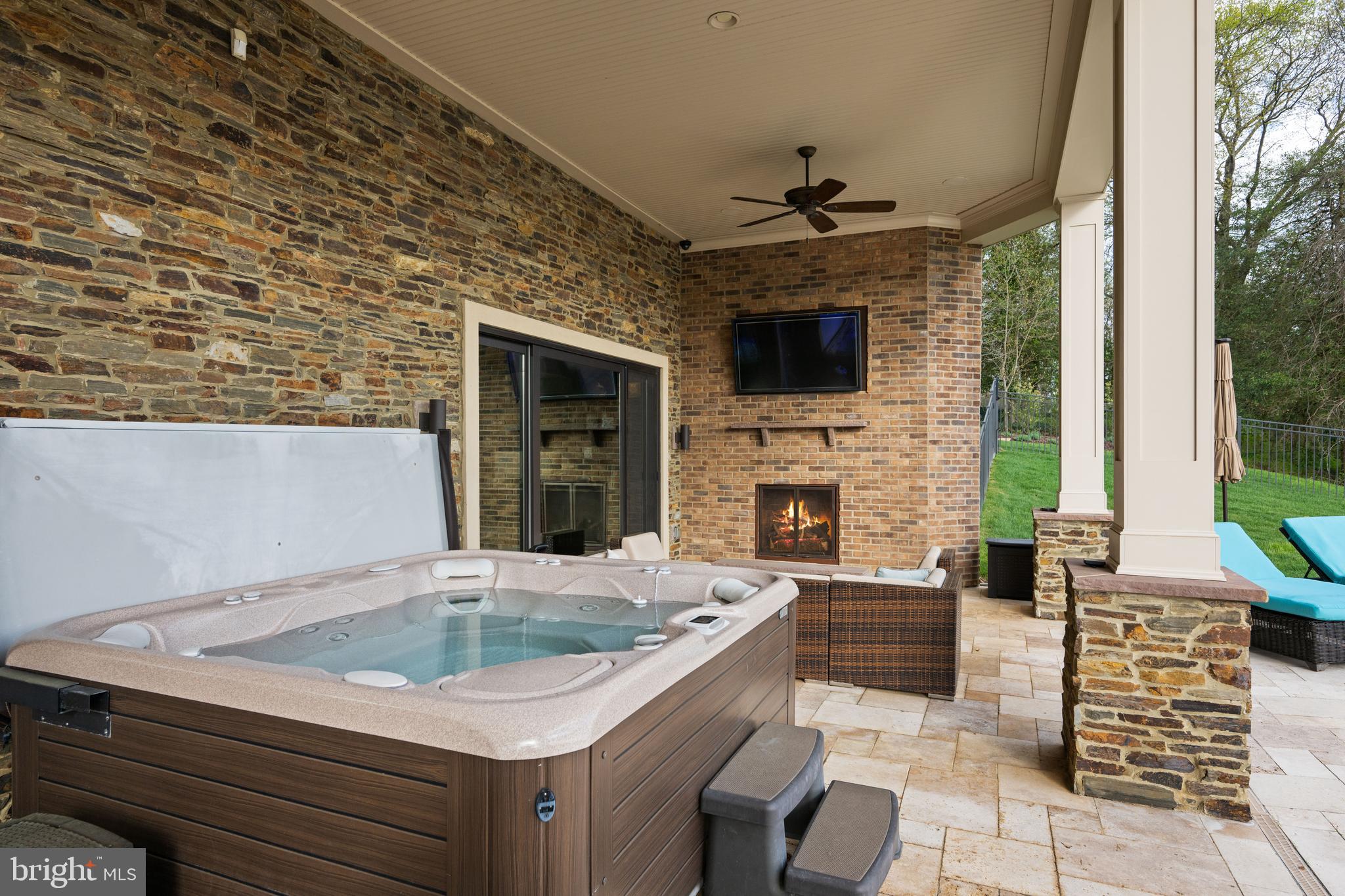 423 Benfield Road Severna Park, MD 21146 - Photo 26 of 50 Covered patio with hot tub and fireplace