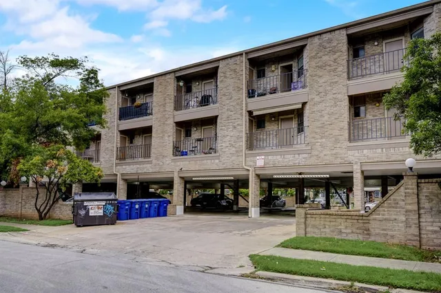 a front view of building with cars parked