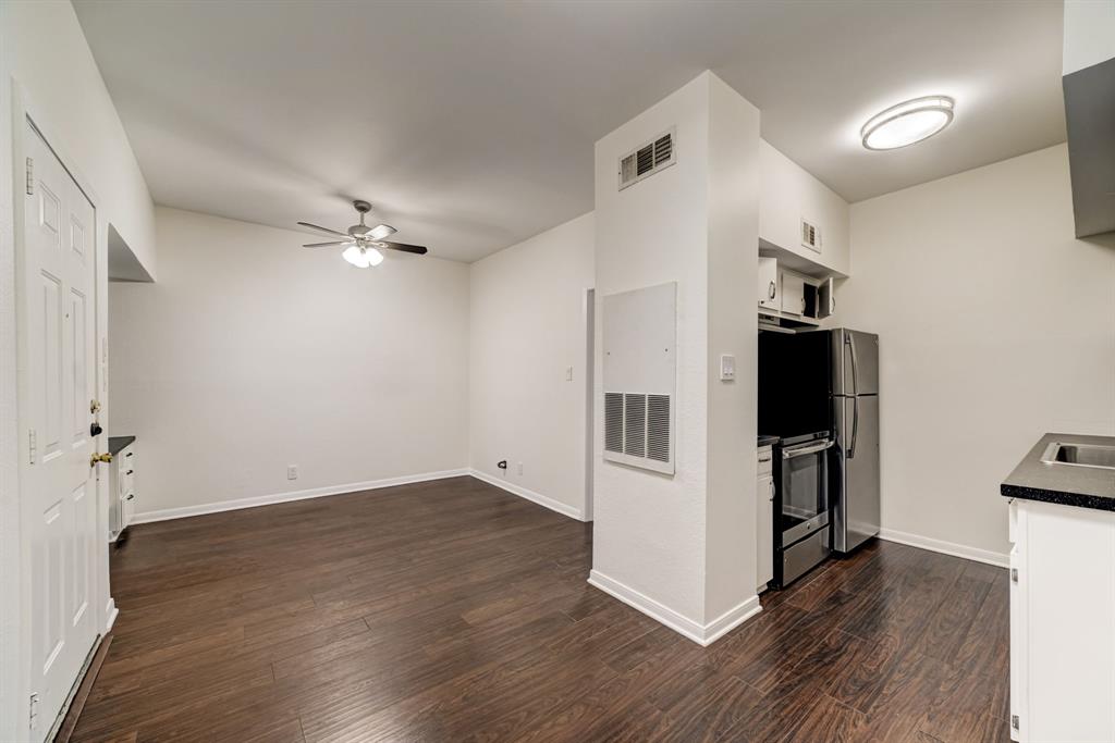 3316 Guadalupe Street, Unit 219 Austin, TX 78705 - Photo 13 of 13 an empty room with wooden floor and white walls