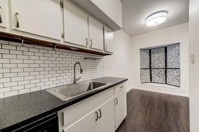 a kitchen with a sink and cabinets