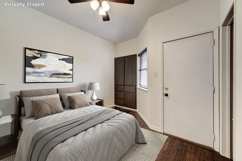 3316 Guadalupe Street, Unit 219 Austin, TX 78705 - Photo 6 of 13 a bedroom with a large bed and a chandelier