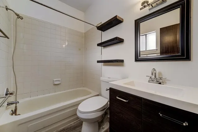 a bathroom with a sink a toilet and bathtub