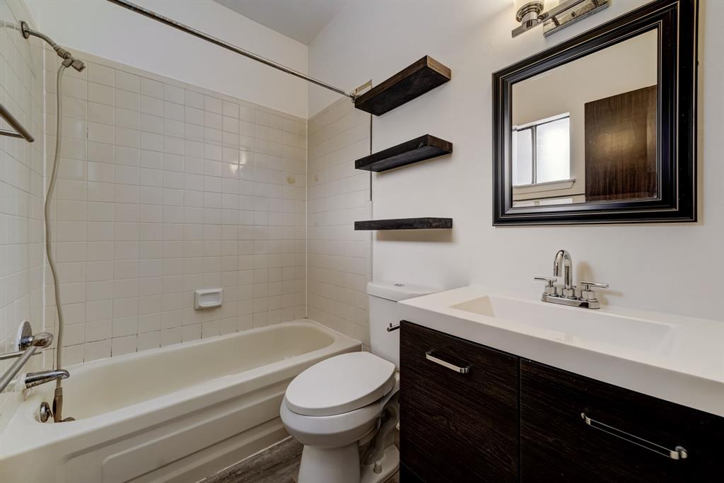 3316 Guadalupe Street, Unit 219 Austin, TX 78705 - Photo 9 of 13 a bathroom with a sink a toilet and bathtub