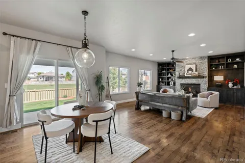 a living room with furniture dining table and a large window