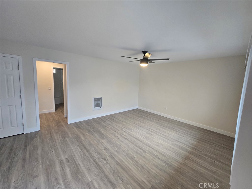 6051 Lemon Avenue, Unit C Cypress, CA 90630 - Photo 12 of 16 a view of a room with wooden floor and white walls