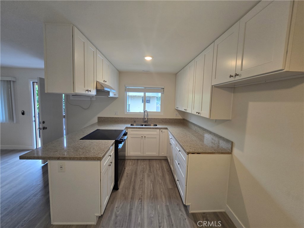 6051 Lemon Avenue, Unit C Cypress, CA 90630 - Photo 13 of 16 a kitchen with a sink a stove and cabinets