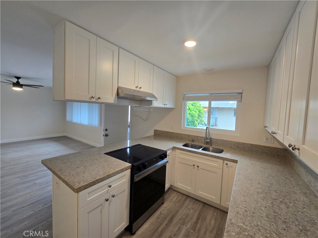 6051 Lemon Avenue, Unit C Cypress, CA 90630 - Photo 14 of 16 a kitchen that has a sink and a stove in it