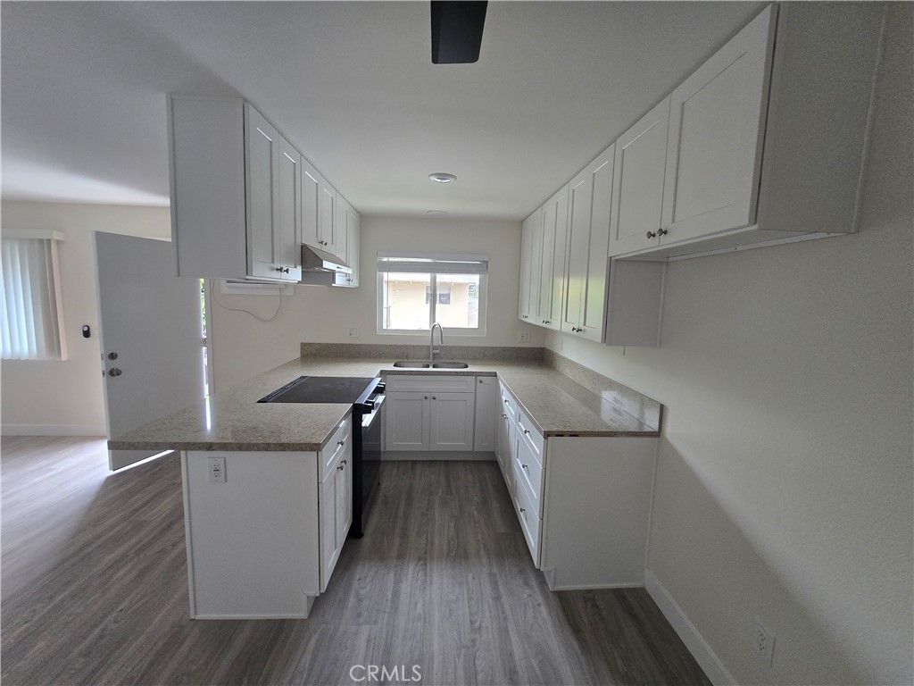 6051 Lemon Avenue, Unit C Cypress, CA 90630 - Photo 2 of 16 a kitchen with a sink a window stainless steel appliances and cabinets