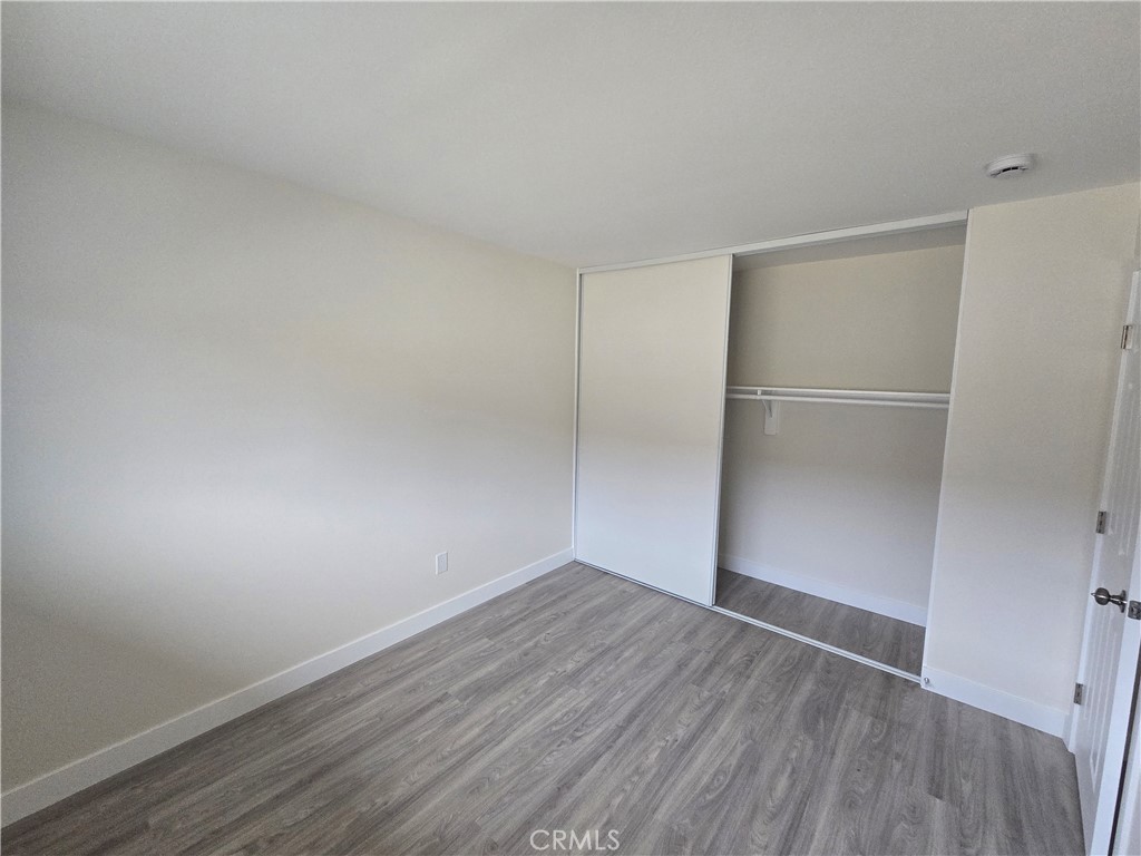6051 Lemon Avenue, Unit C Cypress, CA 90630 - Photo 5 of 16 an empty room with wooden floor and hallway