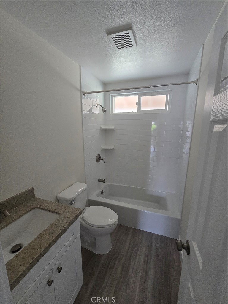 6051 Lemon Avenue, Unit C Cypress, CA 90630 - Photo 6 of 16 a bathroom with a granite countertop sink toilet and shower